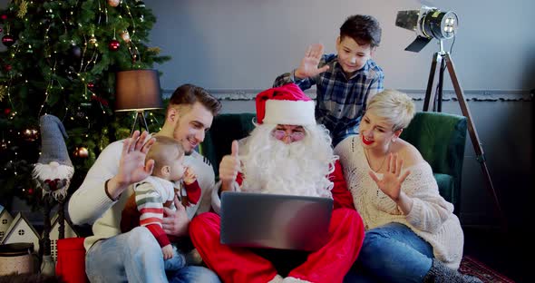 Happy Family Together Santa Claus Sitting Sofa Floors Looking Laptop