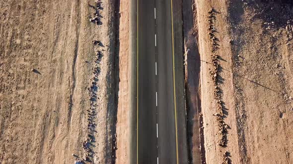 Flying Along a Desert Road with Vertical Panning to Reveal a Hot, Dry Landscape