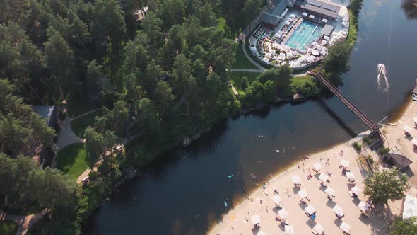 Aerial Top View of River Sand Beach with Hotel Cabins and Pool