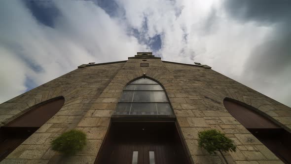 Time lapse of a historical church in Ireland during the day with passing clouds. alt