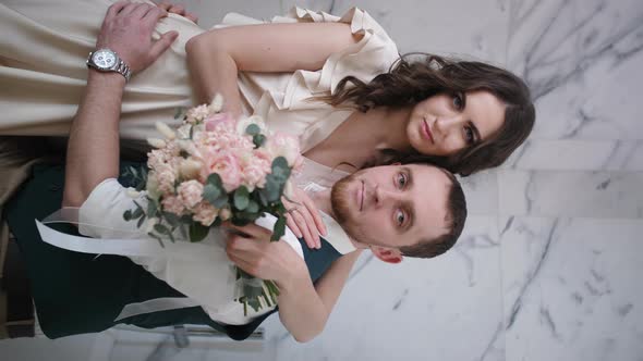 Vertical Portrait of Two Lovers with an Elegant Bouquet