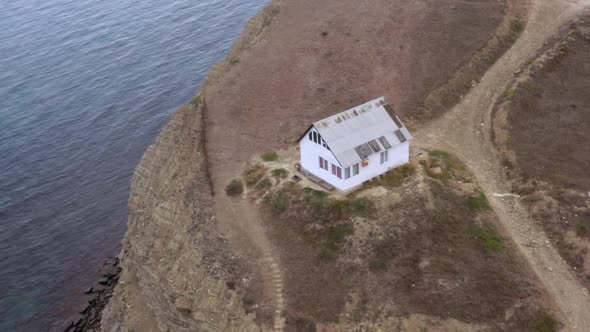 House of Hermit is on Mountain Cliff on Sea Coast