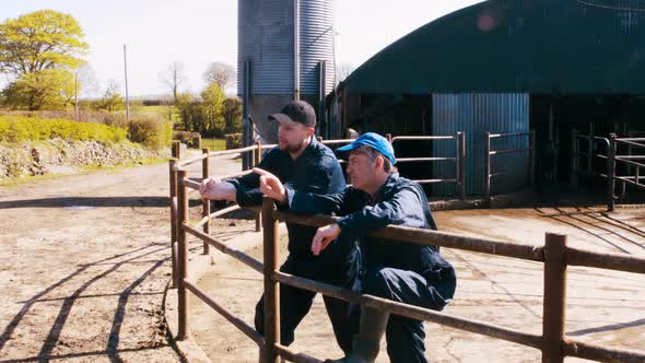 Two cattle farmers interacting with each other