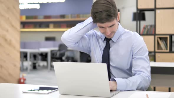 Businessman with Neck Pain at Work