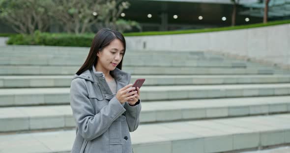 Woman use of mobile phone in city