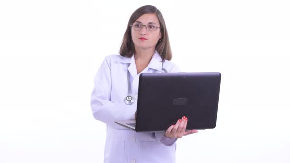 Happy Beautiful Woman Doctor Thinking While Using Laptop