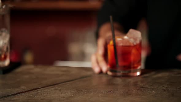 Bartender serving negroni