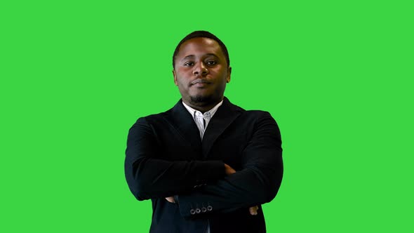 Handsome Black Man in Black Jacket Smiling and Pointing a Finger on a Green Screen Chroma Key