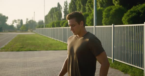 Portrait of a Handsome Strong Man Warming Up Before a Fitness Workout