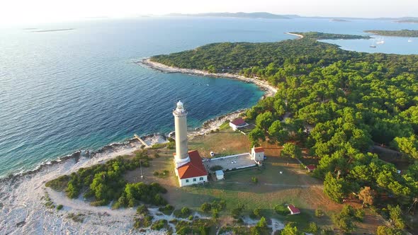 Aerial view of lighthouse, Croatia on forested shore