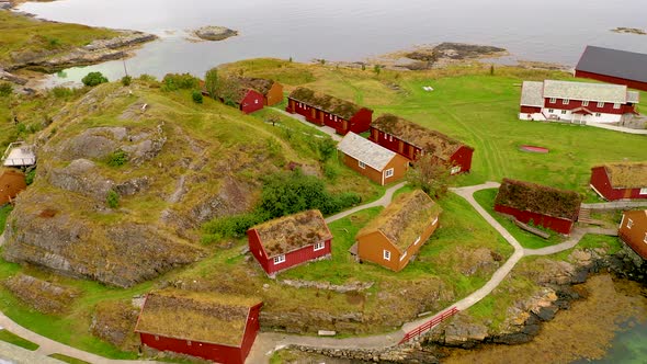 Flying over a small fishing village with Grass roof houses