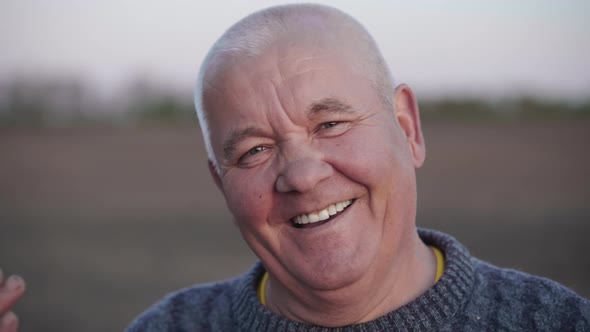 Portrait of a Smiling Senior Adult Man Who Looking Into the Camera