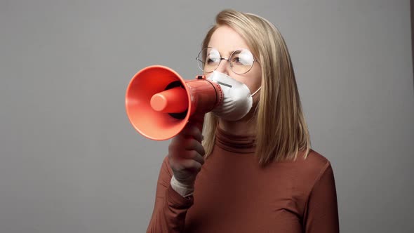 Woman mask with megaphone on grey background