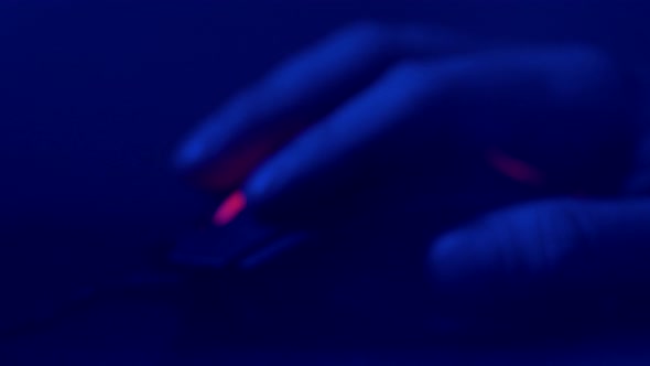 Close Up of Hand Over Wireless Game Mouse on Dark Background The Finger Ready To Click