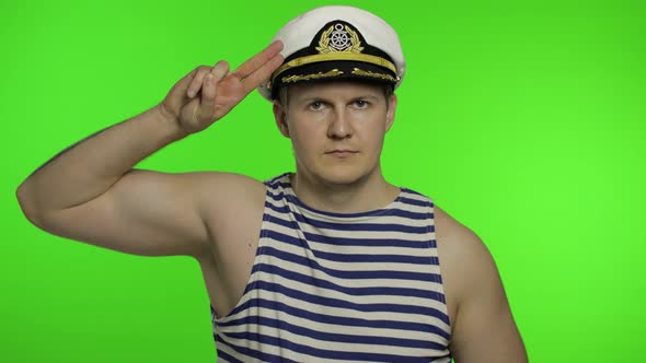 Young Sailor Man Salutes with Hand To Camera. Seaman Guy in Sailor's Vests
