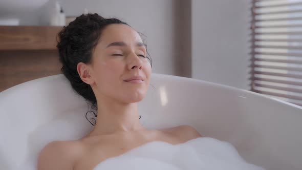 Closeup Young Attractive Relaxed Woman Lying in Hot Foam Bath with Eyes Closed Resting Relaxing in