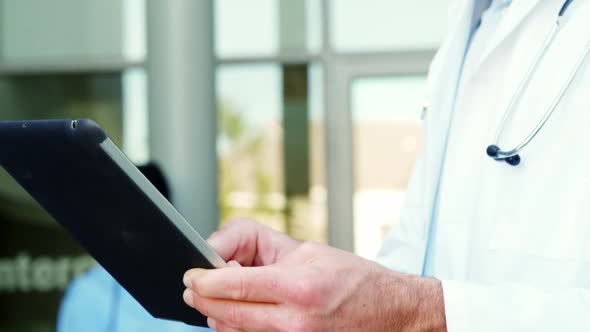 Doctor using a digital tablet in hospital