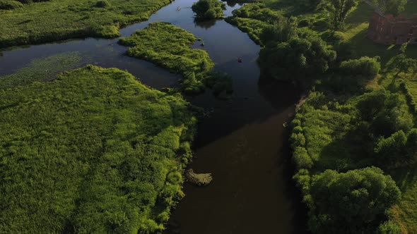 Top View of the Svisloch River Kayakers Floating on the River in the City's Loshitsky Park at Sunset