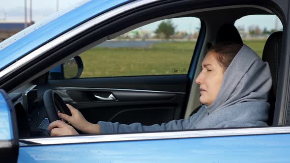 Stressed and Depressed Woman Hits Steering Wheel with Head