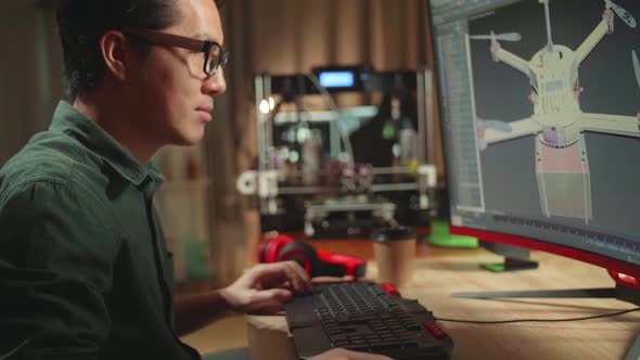 Asian Engineer Working On Personal Computer And 3D Printer, Screen Shows Cad Software