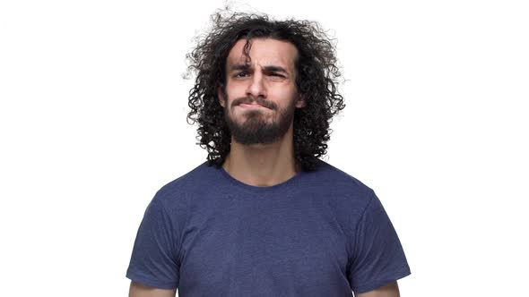 Portrait of Hansdome Man in Casual Dark Blue Tshirt Posing on Camera with Smile and Blowing Locks of