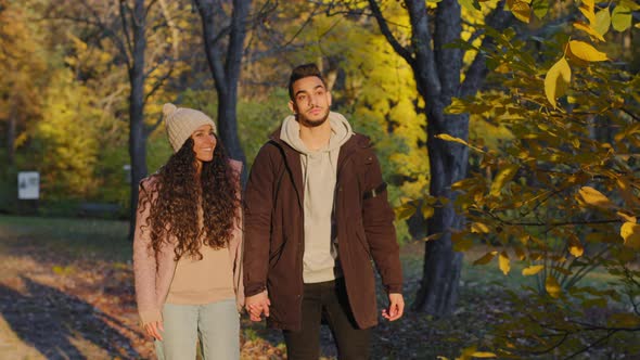 Happy Couple in Love Walking in Autumn Park Hold Hands Enjoy Spending Time Together Outdoors Date in