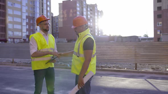 Two Workers Greet and Start to Talk About Their Work