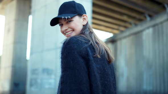 Smiling Woman Standing on City Street. Portrait of Happy Girl Posing at Camera