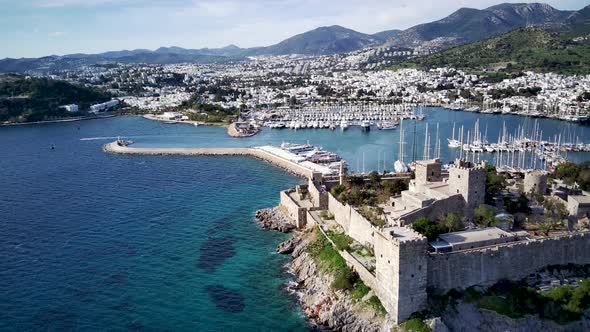 View from drone on full of yachts Bodrum harbour and ancient Kalesi castle in Mugla in Turkey