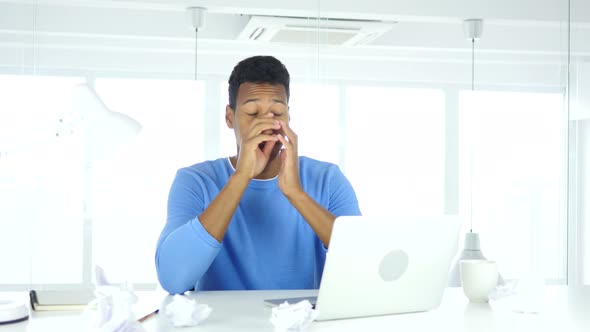 Afro-American Man Frustrated with Paperwork at Work