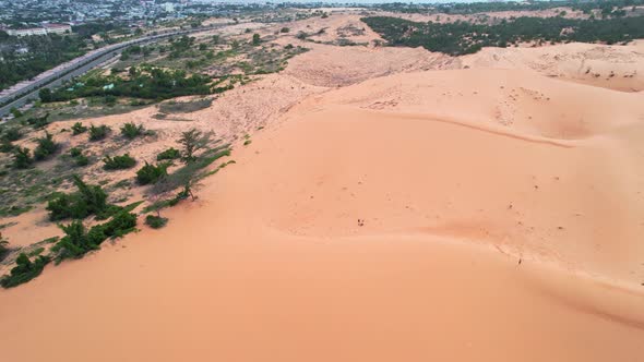 aerial circling a red desert sand dune along the coast of Mui Ne Vietnam