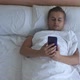 Young Handsome Man Lies in Bed Uses the Phone Before Sleeping - VideoHive Item for Sale