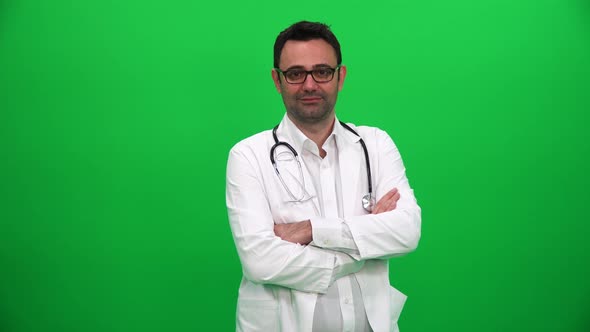 Doctor Looking at Camera on Green Background