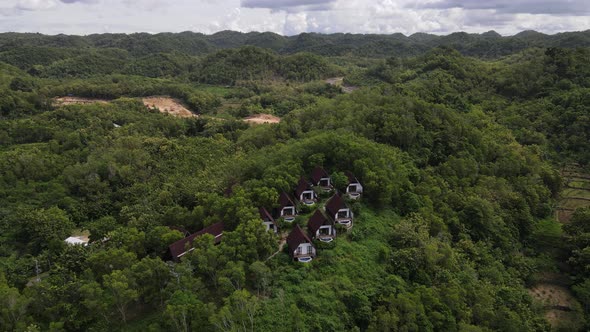 Aerial view of beautiful isolated villa with small swimming pool in the middle of a forest