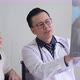 Asian male doctor describe x-ray result to female patient - VideoHive Item for Sale