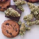 Treatment of Medical Marijuana for Use in Food, Black Background. Cookies with Cannabis and Buds of - VideoHive Item for Sale