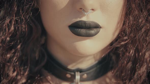 Sexy Gothic Lips with Black Lipstick of Beautiful Woman. Brunette Girl with Mysterious Necklace.