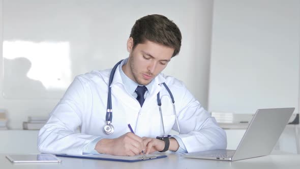 Doctor Writing Prescription for Patient Medical Documents