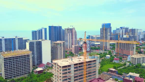 Drone view of a multi-storey building under construction with a tower crane