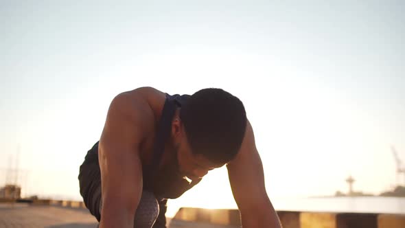 African American Male Athlete in Set Position Preparing for Run Along Sea