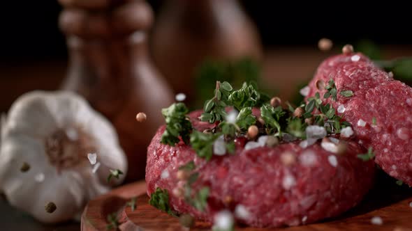 Super Slowmotion Footage of Strewing Salt and Herbs at Fresh Raw Beef Meat Burger 1000Fps