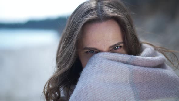 Coquette Beautiful Woman Closing Lower Face with Blanket Looking at Camera Smiling