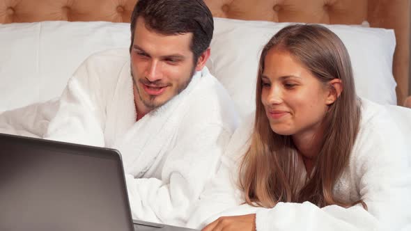 Happy Couple Smiling To the Camera at Their Honeymoon Suite