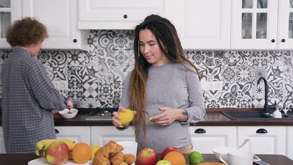 Married Pregnant Couple Preparing Together Breakfast or Dinner on the Beautifully Designeted Kitchen