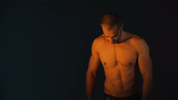 Studio Shot of Handsome Bodybuilder Against Black Background