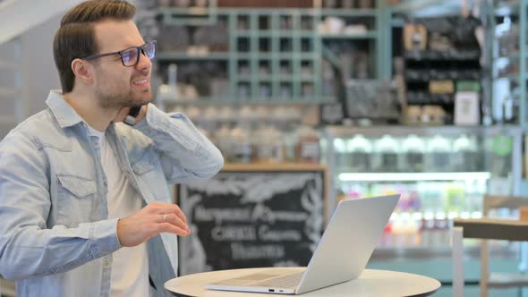 Man Having Neck Pain While Working on Laptop