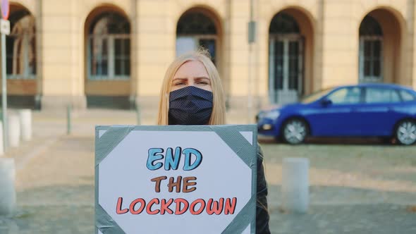 Woman in Mask Asking To End Lockdown on Protest March