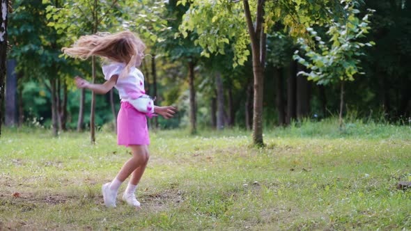 Girl dancing on nature, Cute happy little girl in park