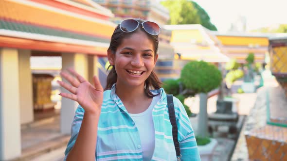 Traveler young asian woman looking at the camera and smiling travel in temple bangkok, Thailand. 