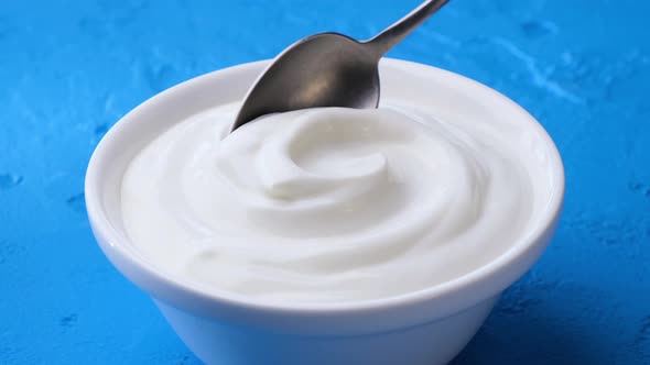 Bowl of Sour Cream on Blue Background Greek Yogurt